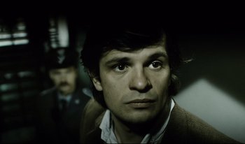 Movie still from “A Short Film About Killing” (1988), directed by Krzysztof Kieslowski – A person wearing a jacket; Close Up shot, High angle