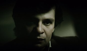 Movie still from “A Short Film About Killing” (1988), directed by Krzysztof Kieslowski – A person's face in the dark; Close Up shot, Low angle