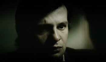 Movie still from “A Short Film About Killing” (1988), directed by Krzysztof Kieslowski – A person's face in the dark; Close Up shot, Over the shoulder angle