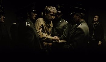 Movie still from “A Short Film About Killing” (1988), directed by Krzysztof Kieslowski – A group of men standing next to each other; Medium shot, High angle