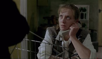 Movie still from “A Short Film About Love” (1988), directed by Krzysztof Kieslowski – A woman sitting in front of a shopping cart; Close Up shot, High angle