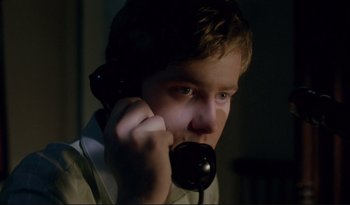 Movie still from “A Short Film About Love” (1988), directed by Krzysztof Kieslowski – A man holding a phone up to his ear; Close Up shot, Low angle