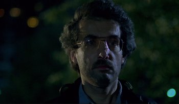 Movie still from “A Short Film About Love” (1988), directed by Krzysztof Kieslowski – A person wearing glasses and a jacket; Close Up shot, Low angle