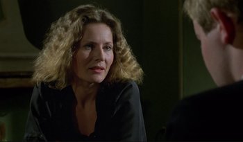 Movie still from “A Short Film About Love” (1988), directed by Krzysztof Kieslowski – A person sitting in a room; Close Up shot, Over the shoulder angle