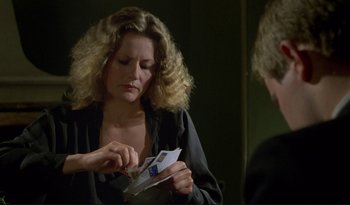 Movie still from “A Short Film About Love” (1988), directed by Krzysztof Kieslowski – A woman looking in the mirror holding a piece of paper; Close Up shot, Over the shoulder angle