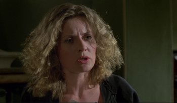 Movie still from “A Short Film About Love” (1988), directed by Krzysztof Kieslowski – A person with curly blonde hair; Close Up shot, Low angle