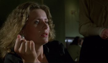 Movie still from “A Short Film About Love” (1988), directed by Krzysztof Kieslowski – A person sitting in a room; Close Up shot, Low angle