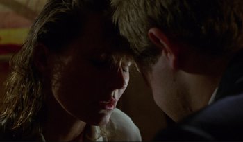 Movie still from “A Short Film About Love” (1988), directed by Krzysztof Kieslowski – A man and a woman looking at one another; Close Up shot, Over the shoulder angle