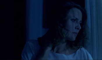 Movie still from “A Short Film About Love” (1988), directed by Krzysztof Kieslowski – A woman is holding her hair in the dark; Close Up shot, Low angle