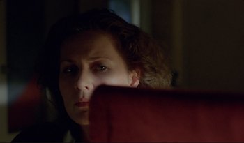 Movie still from “A Short Film About Love” (1988), directed by Krzysztof Kieslowski – A person sitting in a chair; Close Up shot, High angle