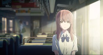 A woman with long hair and a bow tie standing on a bus