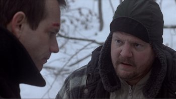 Movie still from “A Simple Plan” (1998), directed by Sam Raimi – A man with a bandage on his head is talking to another man; Close Up shot, Over the shoulder angle