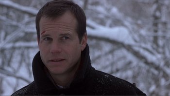 Movie still from “A Simple Plan” (1998), directed by Sam Raimi – A person wearing a black jacket; Close Up shot, Low angle