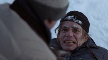 Movie still from “A Simple Plan” (1998), directed by Sam Raimi – A man with a beard and a hat is looking at another man with snow on his face; Close Up shot, Over the shoulder angle