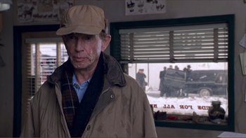 Movie still from “A Simple Plan” (1998), directed by Sam Raimi – An older man wearing a hat and a jacket; Close Up shot, Over the shoulder angle