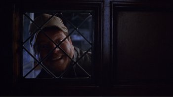 Movie still from “A Simple Plan” (1998), directed by Sam Raimi – A man with a hat is looking through a window; Close Up shot, Low angle