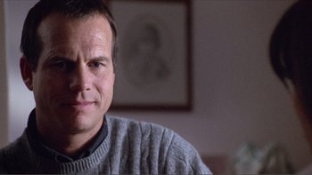 Movie still from “A Simple Plan” (1998), directed by Sam Raimi – A person sitting in a room; Close Up shot, Low angle