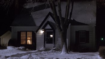 Movie still from “A Simple Plan” (1998), directed by Sam Raimi – A house with a tree in front of it at night; Extreme Wide shot, High angle