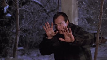 Movie still from “A Simple Plan” (1998), directed by Sam Raimi – A man in a black shirt is holding his hands up; Close Up shot, Low angle