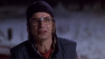 Movie still from “A Simple Plan” (1998), directed by Sam Raimi – A person wearing glasses and a hat; Close Up shot, Over the shoulder angle