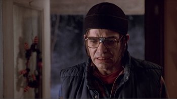 Movie still from “A Simple Plan” (1998), directed by Sam Raimi – An older man wearing glasses and a hat; Close Up shot, Low angle