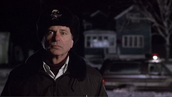 Movie still from “A Simple Plan” (1998), directed by Sam Raimi – A man wearing a black hat and a black jacket; Close Up shot, Low angle