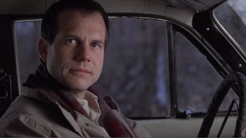 Movie still from “A Simple Plan” (1998), directed by Sam Raimi – A man sitting in the back seat of a car; Close Up shot, Low angle