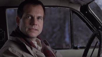 Movie still from “A Simple Plan” (1998), directed by Sam Raimi – A man sitting in the back seat of a car; Close Up shot, Low angle