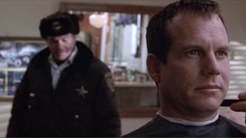 Movie still from “A Simple Plan” (1998), directed by Sam Raimi – A man in a police uniform is looking at another man in a uniform; Close Up shot, Over the shoulder angle