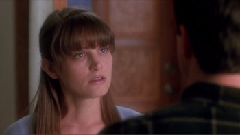 Movie still from “A Simple Plan” (1998), directed by Sam Raimi – A young woman with bangs is talking to a man; Close Up shot, Over the shoulder angle
