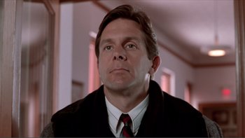 Movie still from “A Simple Plan” (1998), directed by Sam Raimi – A person wearing a suit and tie; Close Up shot, Low angle
