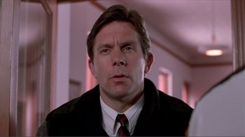 Movie still from “A Simple Plan” (1998), directed by Sam Raimi – A person wearing a suit and tie; Close Up shot, Low angle