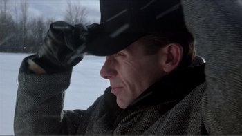 Movie still from “A Simple Plan” (1998), directed by Sam Raimi – A person wearing a hat in the snow; Close Up shot, Low angle