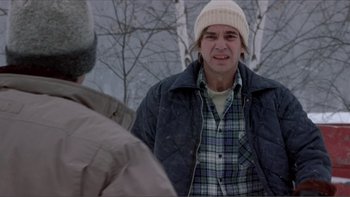 Movie still from “A Simple Plan” (1998), directed by Sam Raimi – A man in a plaid shirt and a hat is looking at another man in a black jacket; Medium shot, Over the shoulder angle