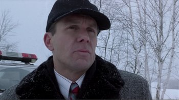 Movie still from “A Simple Plan” (1998), directed by Sam Raimi – A person wearing a hat and a jacket; Close Up shot, Low angle