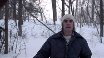 Movie still from “A Simple Plan” (1998), directed by Sam Raimi – A man standing in the middle of a snow covered field; Close Up shot, Low angle