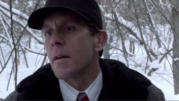 Movie still from “A Simple Plan” (1998), directed by Sam Raimi – A person wearing a hat and a jacket; Close Up shot, Low angle
