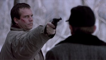 Movie still from “A Simple Plan” (1998), directed by Sam Raimi – A man is pointing a gun at another man; Close Up shot, Over the shoulder angle