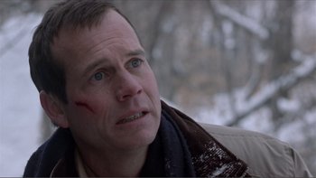 Movie still from “A Simple Plan” (1998), directed by Sam Raimi – A person with a scar on his face; Close Up shot, Low angle