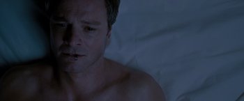 Movie still from “A Single Man” (2009), directed by Tom Ford – A person laying in a bed; Close Up shot, Overhead angle