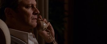 Movie still from “A Single Man” (2009), directed by Tom Ford – An older man is talking on a phone; Close Up shot, Low angle