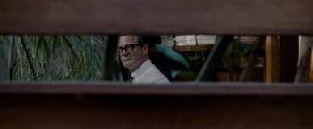 Movie still from “A Single Man” (2009), directed by Tom Ford – A man with glasses looking at himself in a mirror; Medium shot, Low angle