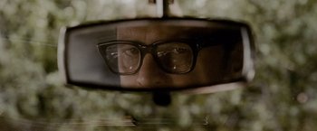 Movie still from “A Single Man” (2009), directed by Tom Ford – A man wearing glasses looking out of a car window; Extreme Close Up shot, Over the shoulder angle