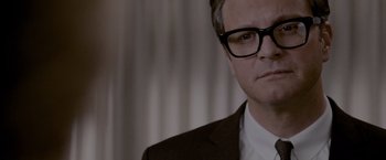 Movie still from “A Single Man” (2009), directed by Tom Ford – A person wearing a suit and glasses; Close Up shot, Over the shoulder angle