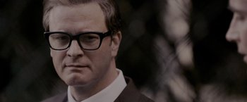 Movie still from “A Single Man” (2009), directed by Tom Ford – A person wearing glasses and a suit; Close Up shot, Low angle