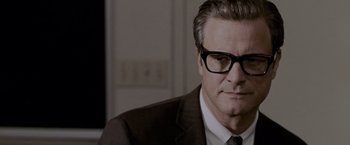 Movie still from “A Single Man” (2009), directed by Tom Ford – A person wearing a suit and glasses; Close Up shot, Over the shoulder angle