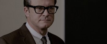 Movie still from “A Single Man” (2009), directed by Tom Ford – A person wearing glasses and a suit; Close Up shot, Over the shoulder angle
