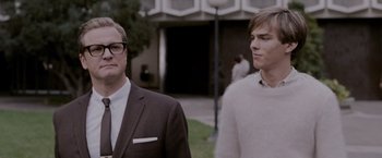 Movie still from “A Single Man” (2009), directed by Tom Ford – Two men standing next to each other in front of a building; Medium shot, Over the shoulder angle