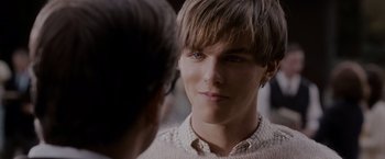 Movie still from “A Single Man” (2009), directed by Tom Ford – A young man looking into a mirror while wearing glasses; Close Up shot, Over the shoulder angle