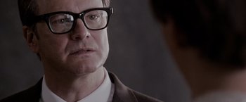 Movie still from “A Single Man” (2009), directed by Tom Ford – A person wearing a suit and glasses; Close Up shot, Over the shoulder angle